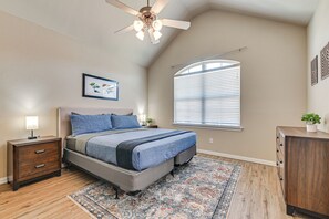 A bedroom with a bed, nightstand, dresser, ceiling fan, window with blinds, and a rug. - Lewisville Home w/ Pool Access: Walkable Location (Lewisville)