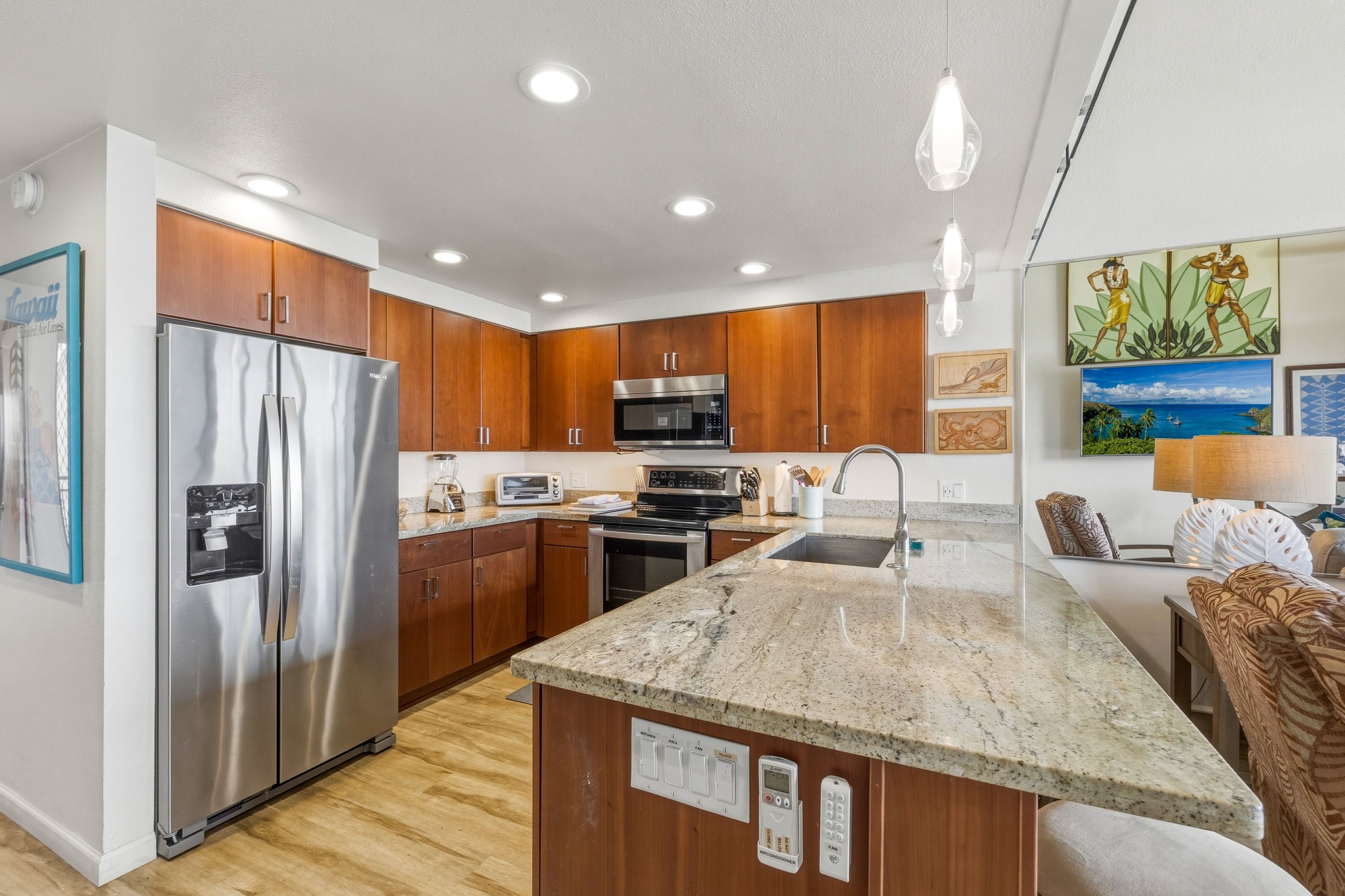 A modern kitchen with wooden cabinets, stainless steel appliances, a granite countertop, and a central island.