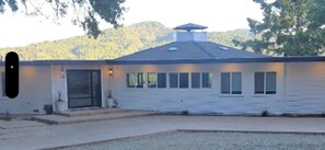 A single-story building with a flat roof, a front entrance, and multiple windows.