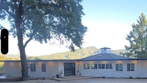 A single-story building with a flat roof, a front entrance, and a covered porch area.