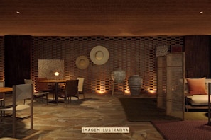 A room with a brick wall, a wooden table, chairs, and a sofa.