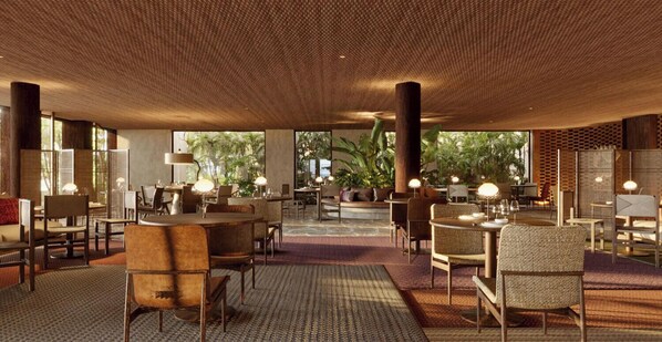 A spacious indoor area with multiple seating arrangements, including tables and chairs, and a ceiling with a textured pattern.