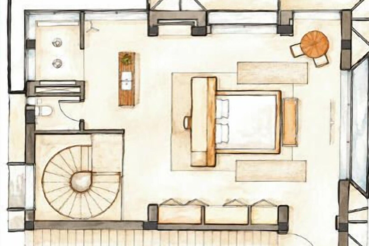 Distribució d'una habitació d'hotel amb llit, zona de seients i cuina petita.