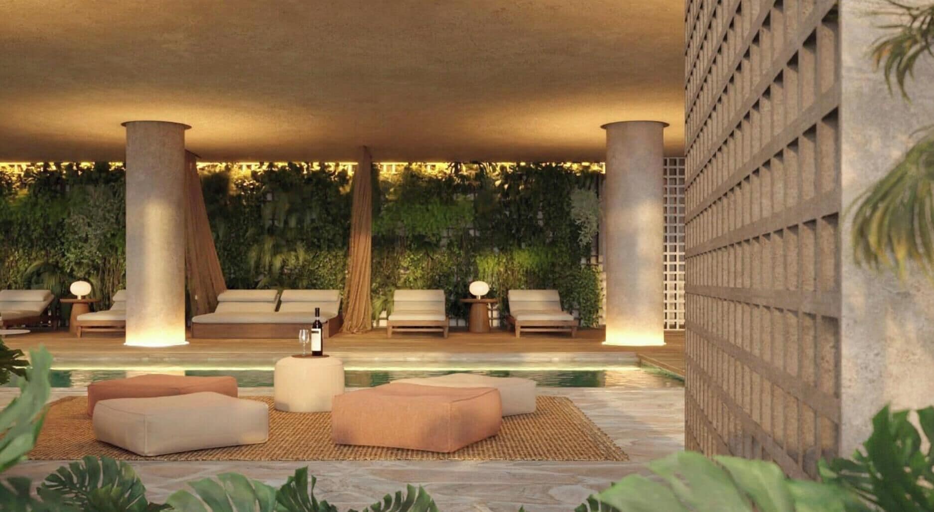 A modern lounge area with seating, a pool, and lush greenery.