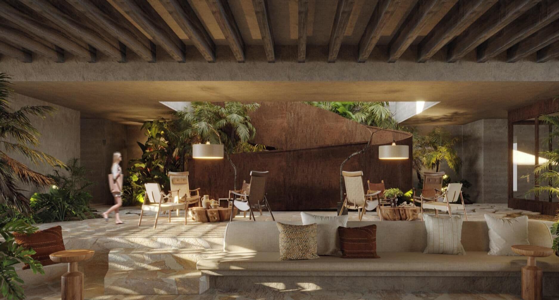 An indoor lounge area with a stone floor, wooden furniture, and potted plants.