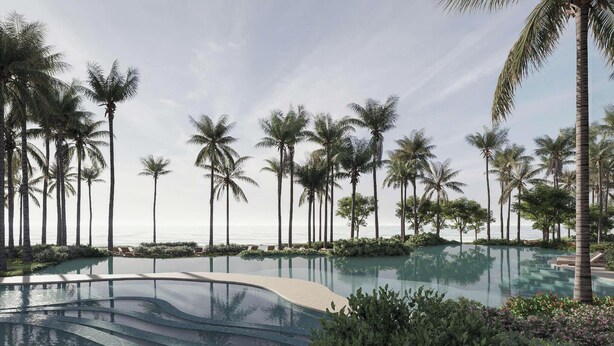 Un resort con una amplia piscina infinita rodeada de palmeras y vistas al océano.