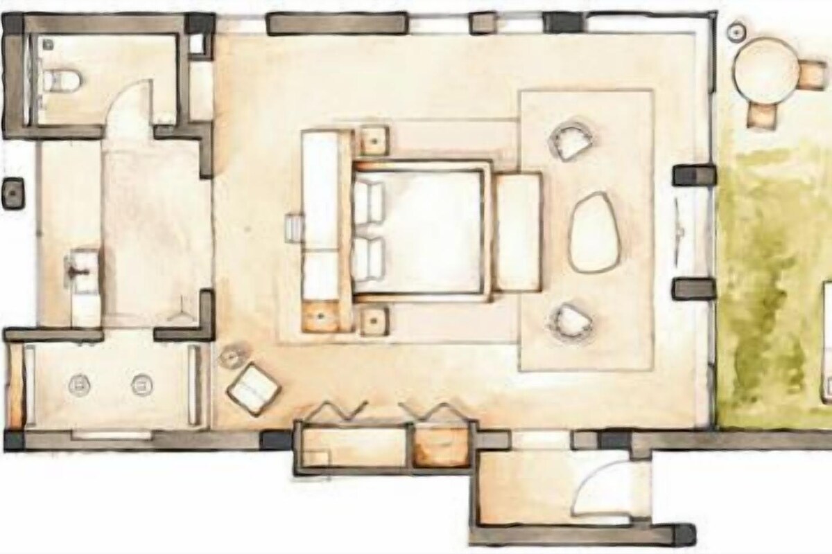 Plànol d'un hotel que mostra una zona de dormitar central, un bany, una zona d'estar amb taula i cadires, i una petita zona exterior amb seients.