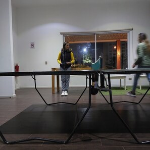 Une pièce comprenant une table et des chaises, un extincteur et une fenêtre donnant sur l’extérieur.