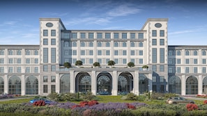 A large, symmetrical building with multiple windows and a central entrance with arches. - Baku Resort & Spa (Issyk-Kul Region)