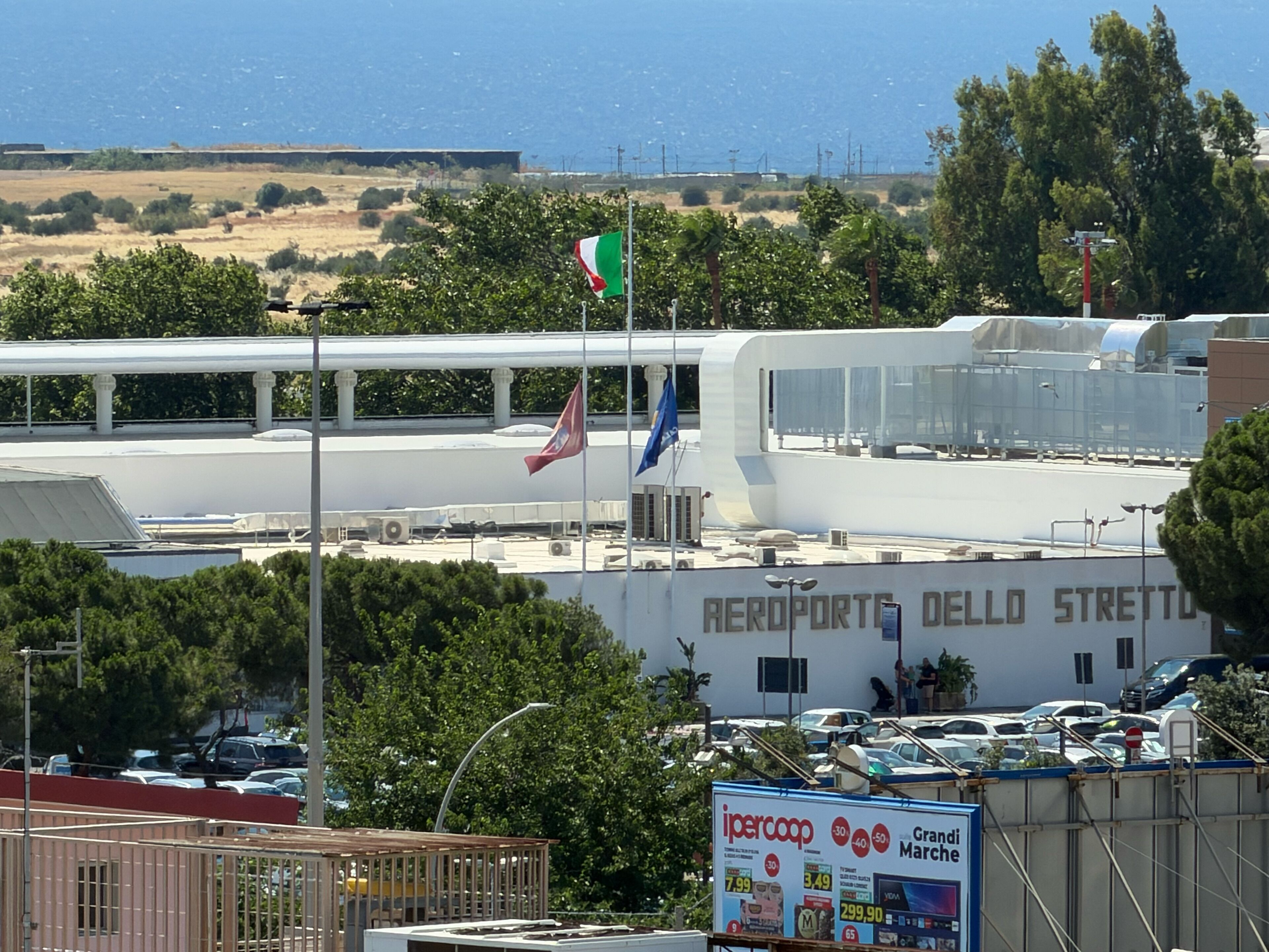 An airport terminal with a sign reading 'AEROPORTO DELLO STRETTO.'