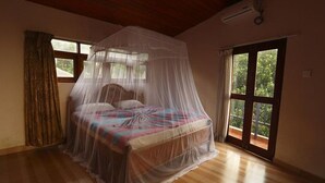 Un dormitorio con una cama bajo dosel, una ventana y una puerta que da al exterior.