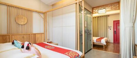 A hotel room with a wooden bed, a mirror, a red door, and a traditional Asian-style wall panel.