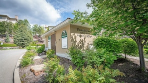 A building labeled 'Pinnacle Pointe' with a sign indicating condos for sale. - Mountain View w Pool and Hot Tub 2213 (Kelowna)