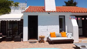 A white building with a tiled roof, a small pool, and outdoor furniture. - Private Pool • 8-Min Walk to Praia da Oura Beach • Prime Albufeira Location (Albufeira)