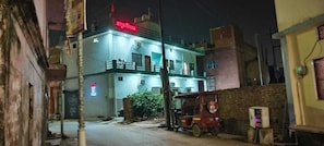 A two-story building with a balcony, a signboard, and a parked vehicle. - Amrit Niwas (Ayodhya)
