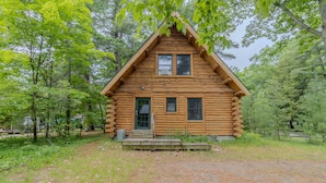 A log cabin with a front porch, two windows, and a door. - Walk to Elk Rapids + Steps from East GT Bay (Elk Rapids)