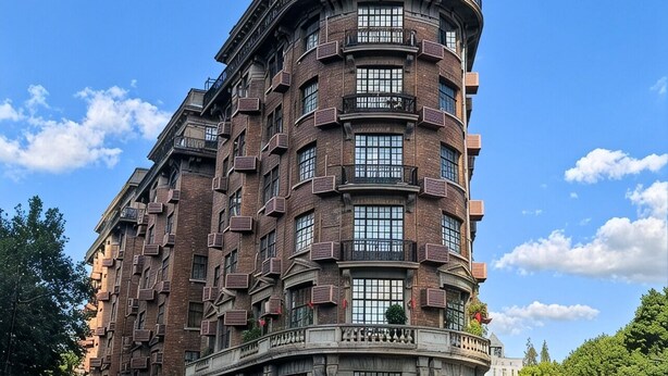A multi-story building with a curved corner, large windows, and balconies. - Shanghai Weikesun Business Hotel (Shanghai)