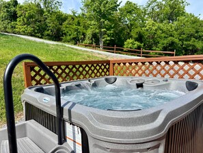 A hot tub with a wooden deck and a view of a grassy area with trees. - Antler Ridge - surrounded by nature & wildlife! (Page County)