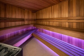 A sauna with wooden benches and a tiled floor. - CBD Apt Sky Tower View by Zodiak Stays (Auckland Central)