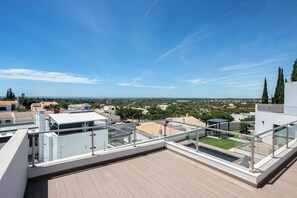 A rooftop terrace with a clear view of the surrounding neighborhood, including trees and buildings. - Villa Miradouro Do Sul by Marenssa (Moncarapacho)