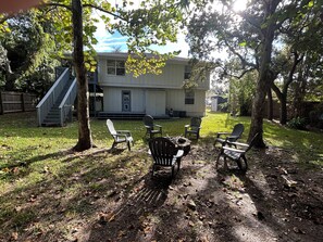 A two-story house with a covered porch, a staircase, and outdoor seating. - The Native-Vintage Florida Vibe in the Oldest City (St. Augustine)