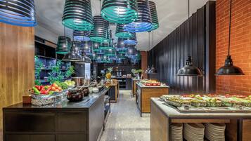 A modern kitchen with stainless steel appliances, wooden cabinets, and a brick wall.
