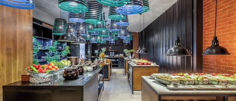 A modern kitchen with stainless steel appliances, wooden cabinets, and a brick wall.