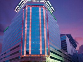 A high-rise building with a modern glass facade and a prominent corner entrance.