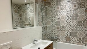 A bathroom with a white sink, wooden vanity, and a shower. - REFLETS D'ARDENT 101  By Avecoeur (Montriond)