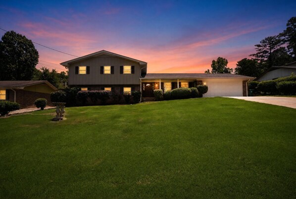 A two-story house with a well-maintained lawn, a garage, and a driveway. - NEW! Private Pool Oasis 15 mins to World Cup Sleeps 10 (Decatur)