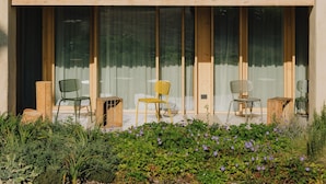 A two-story building with a balcony, large windows, and outdoor seating. - Villa del Brolo - Famiglia Furia (Mezzane di Sotto)