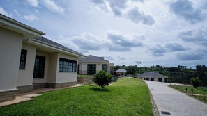 A row of modern buildings with a well-maintained lawn and paved walkway.