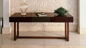 A modern interior with a tiled wall, a wooden table, and three pendant lights. - Walk Bueno (Goiânia)