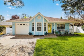 A single-story house with a garage, a front porch, and a well-maintained lawn.