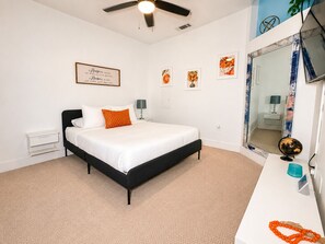 A bedroom with a bed, a desk, a mirror, and artwork on the walls. - Cozy 1BR Apartment in Atlanta – Prime Location Near Midtown & Downtown (Atlanta)