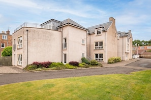 A residential building with a flat roof, multiple windows, and a paved driveway. - Southfield Apartments (No 15) | St Andrews (St Andrews)