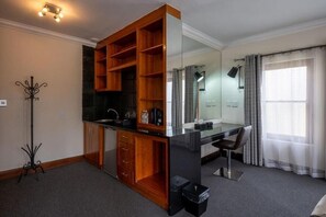 A modern bathroom with a glass shower enclosure, a wooden vanity, and a mirror. - IL Castello Boutique Hotel (Clarens)