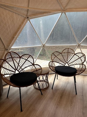 A tented room with two heart-shaped wicker chairs and a small round table. - Dome Tent Retreat with Private Wood-Fired Hot Tub in Branchville, South Carolina (Branchville)