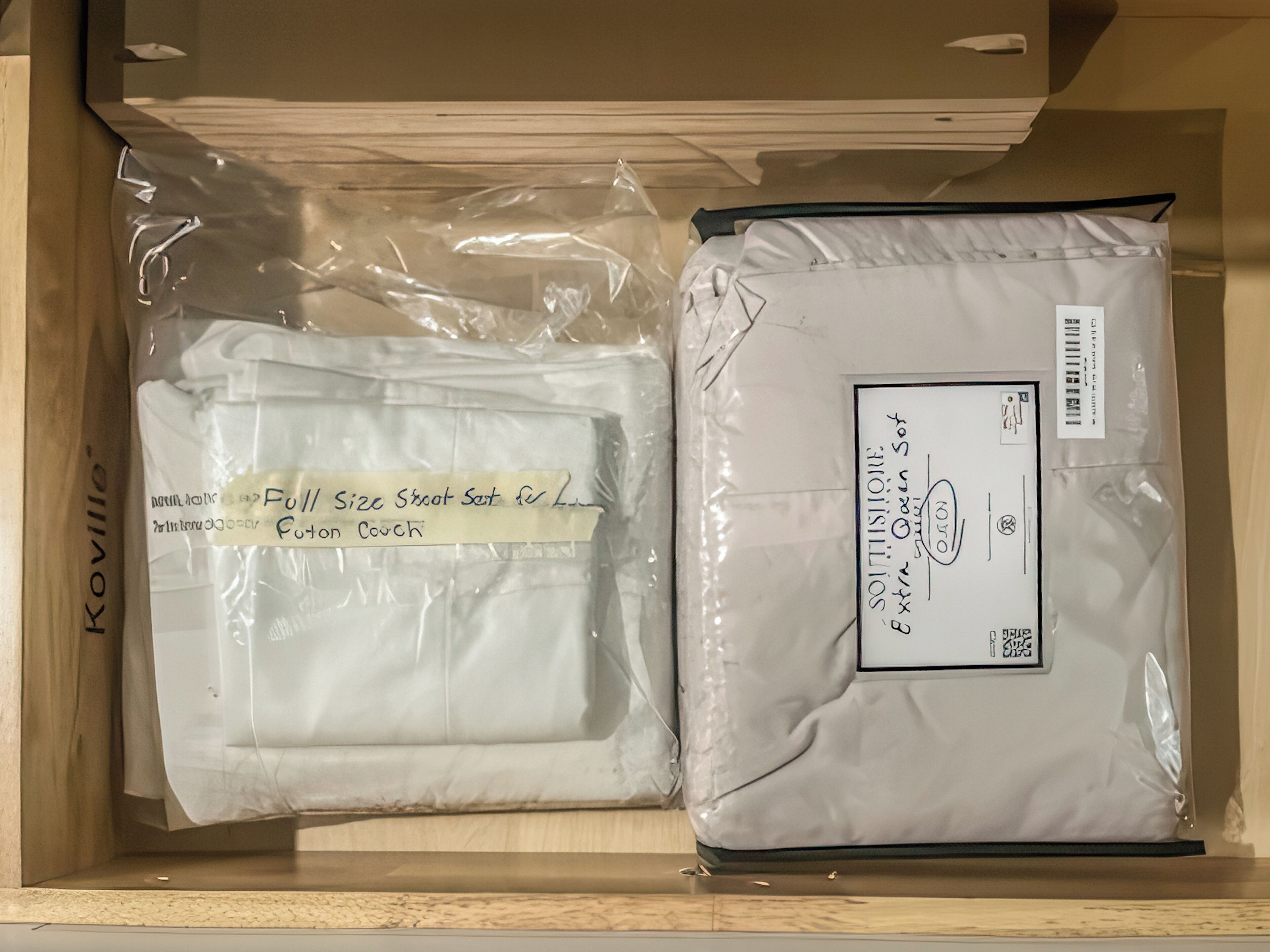 A storage box containing folded items labeled 'Full Size Street Set for Lin' and 'Futon Couch.'