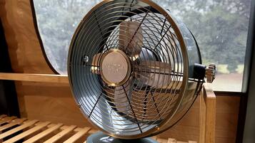A fan with a circular grill and a label on the front.