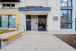 A modern building entrance with a sign reading 'U PLYNÁRNY 1597/50'. - Blueground | Michle, private garden, nr Vysehrad (PRG-99) (Prague)