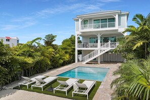 A two-story house with a swimming pool, a balcony, and a white fence. - Beach Walk to Sombrero (Marathon)