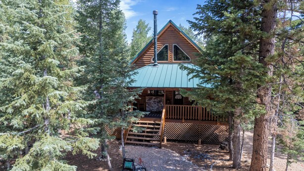 A cabin with a sloped roof, wooden exterior, and a stone foundation. - Luxury Cottage w/NEW HOT TUB near National Parks and Loaded with Amenities (Duck Creek Village)