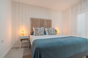 A bedroom with a bed, bedside tables, and a wall-mounted headboard. - Vacation Apartment 'Isabel 2' with Wi-Fi and Air Conditioning (Guargacho)