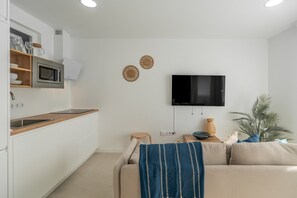 A modern kitchen with a microwave, a wooden countertop, and a built-in oven. - Vacation Apartment 'Isabel 3' with Balcony, Wi-Fi and Air Conditioning (Guargacho)