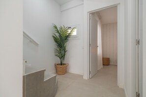 A hallway with a potted plant, a window, and a door leading to another room. - Vacation Apartment 'Isabel 5' with Private Terrace, Wi-Fi and Air Conditioning (Guargacho)