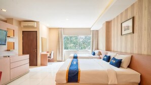 A hotel room with a bed, a desk, a TV, and a window. - Sweet Karina Hotel Pasteur (Bandung)
