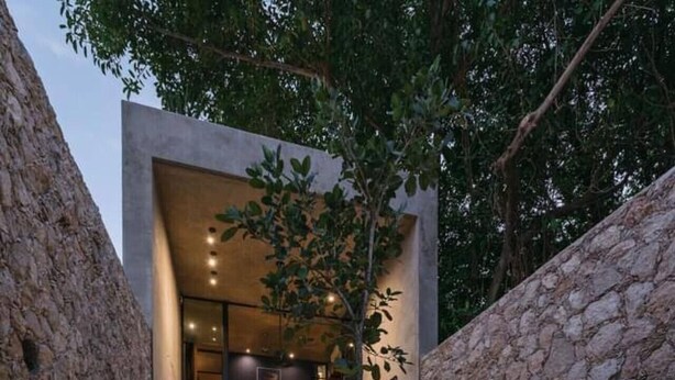 A modern outdoor patio with a pool, stone walls, and a dining area. - Award-winning Casa El Nido in Santa Lucia (Centro)