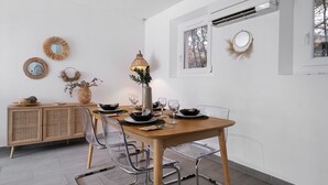 A dining area with a wooden table, clear chairs, and a buffet cabinet. - Villa "les alizés" garden side, close to the sea (Saint-Raphaël)