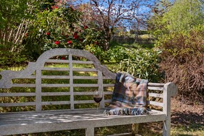 A wooden bench with a plaid blanket and a glass of red wine. - Smithy Cottage -  Beauly , Scottish Highlands, Scotland (Beauly)